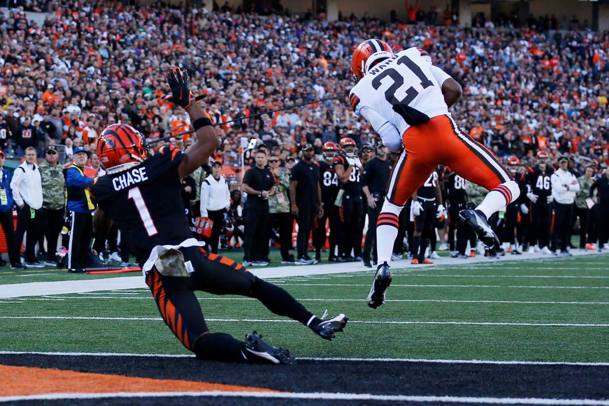 Denzel Ward jumps to intercept a pass with Cincinnati Bengals wide receiver Ja'Marr Chase behind him