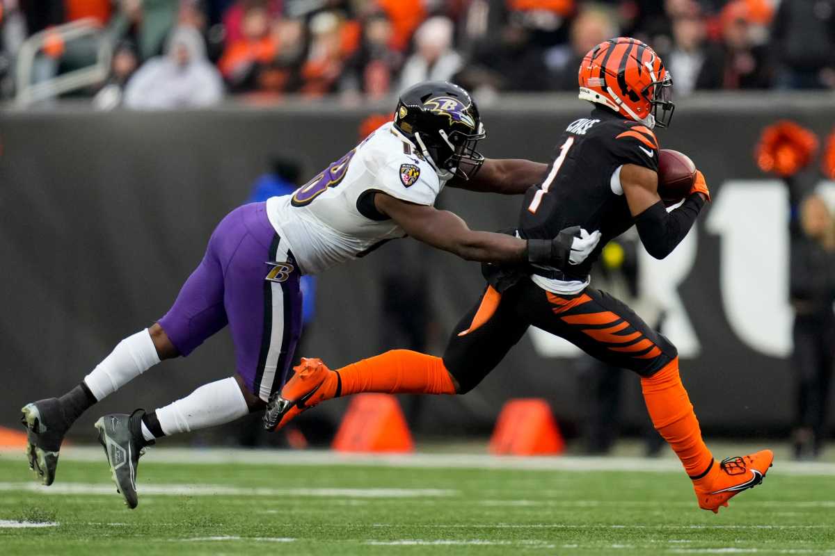 wide receiver Ja'Marr Chase runs with the ball as Baltimore Ravens linebacker Roquan Smith reaches out to try to tackle him