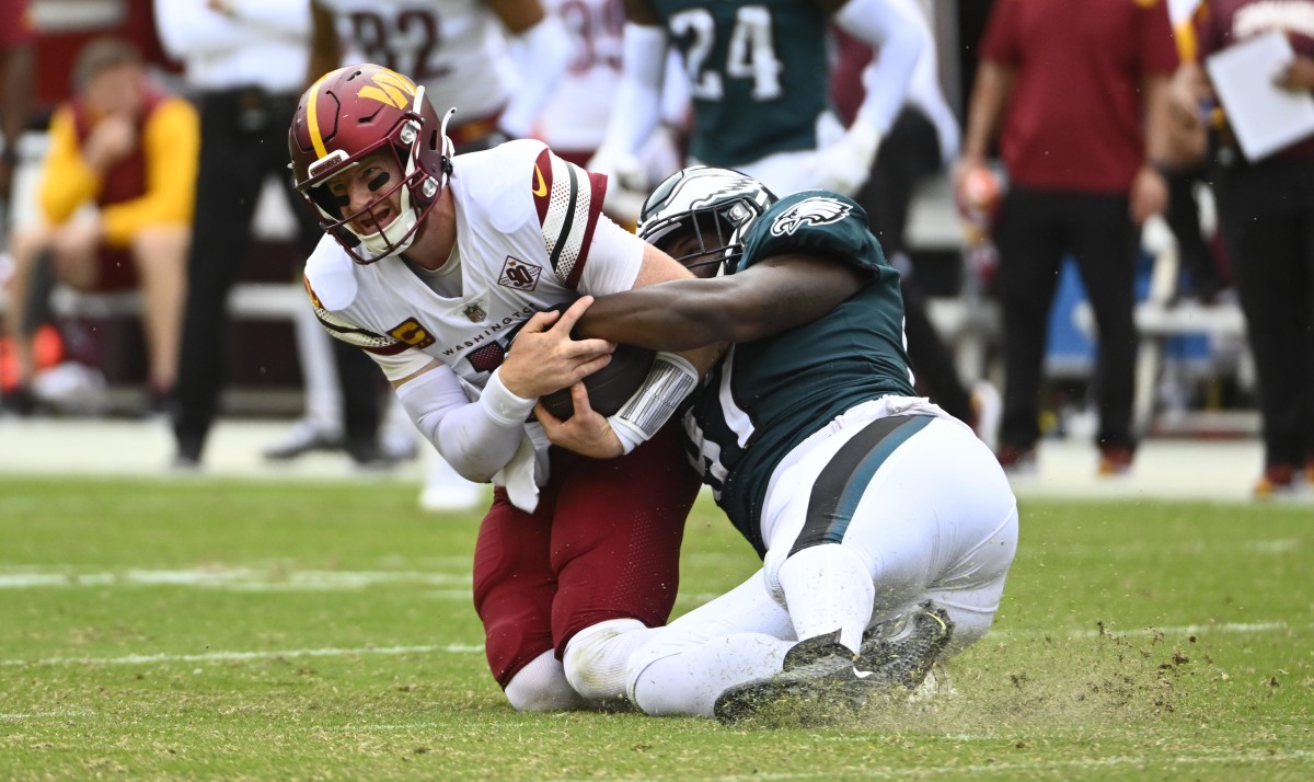 Philadelphia Eagles defensive tackle Javon Hargrave (97) tackles Washington Commanders quarterback Carson Wentz