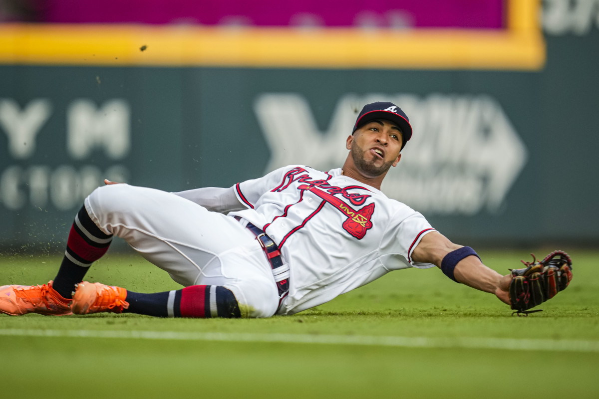 Aug 22, 2023; Cumberland, Georgia, USA; Atlanta Braves left fielder Eddie Rosario (8) makes a sliding catch on a ball hit by New York Mets shortstop Francisco Lindor (12) (not shown) during the first inning at Truist Park.