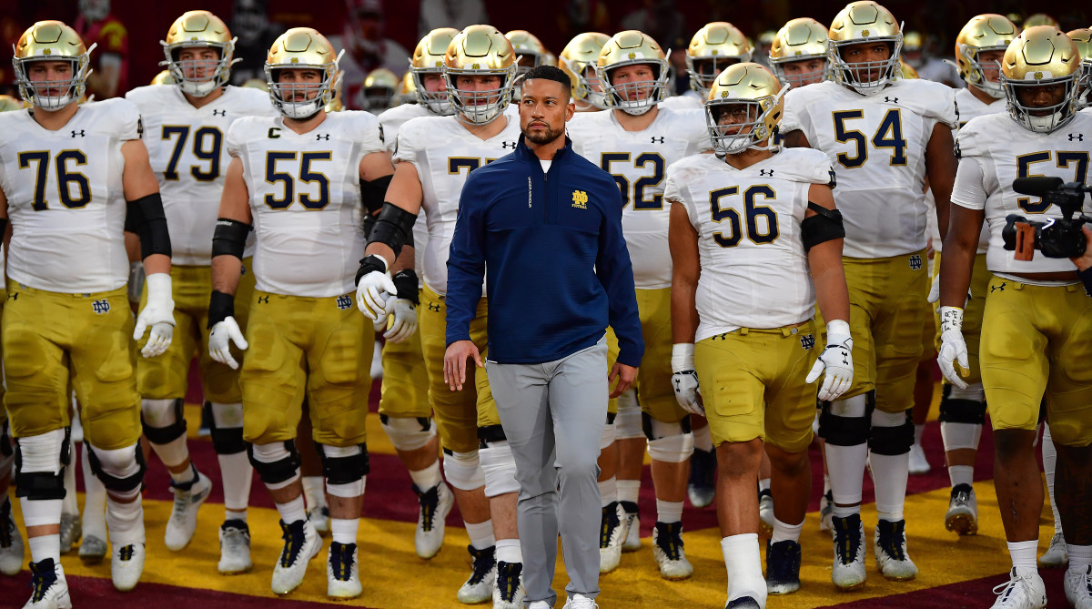 Notre Dame coach Marcus Freeman leads the team onto the field vs. USC.