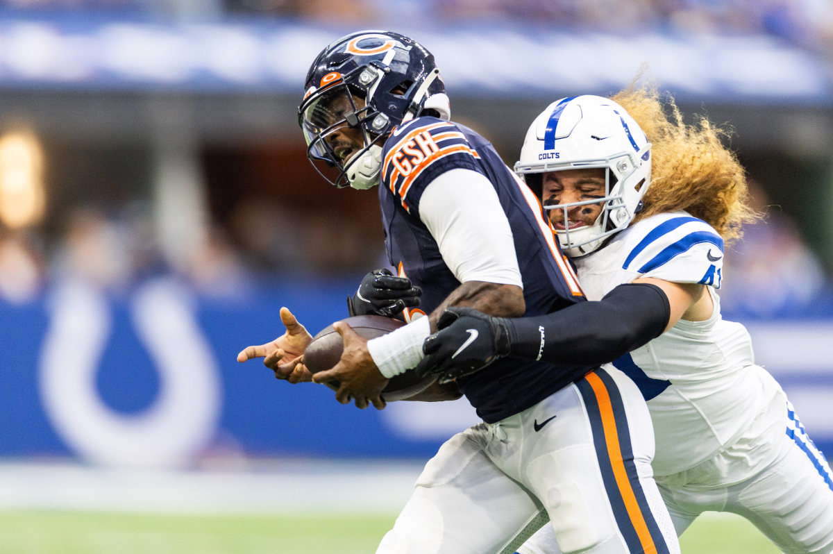 Aug 19, 2023; Indianapolis, Indiana, USA; Indianapolis Colts linebacker Grant Stuard (41) sacks Chicago Bears quarterback PJ Walker (15) in the first quarter at Lucas Oil Stadium.