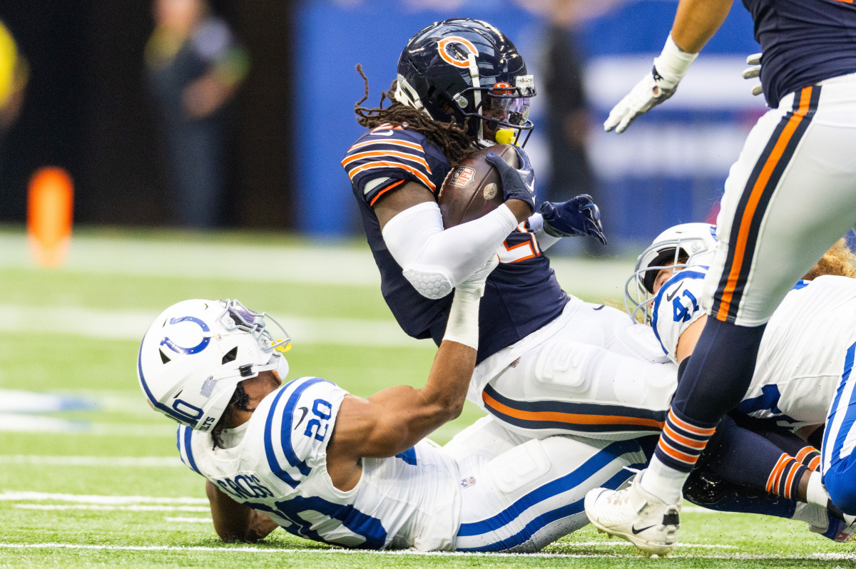 Aug 19, 2023; Indianapolis, Indiana, USA; Chicago Bears running back D'Onta Foreman (21) is tackled by Indianapolis Colts safety Nick Cross (20) in the first quarter at Lucas Oil Stadium.