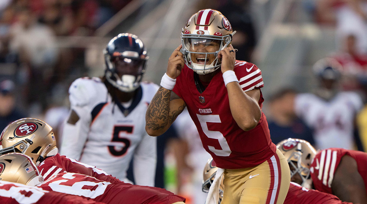 Trey Lance makes a call behind the line of scrimmage during a preseason game.