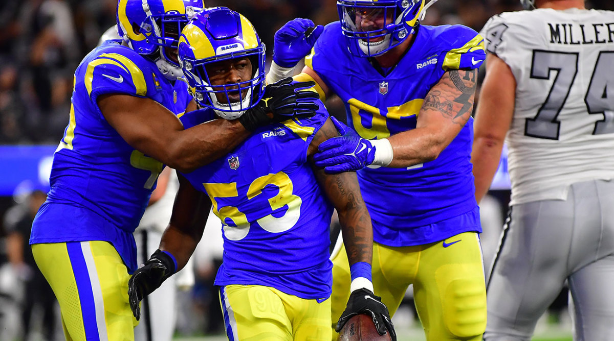 Rams linebacker Ernest Jones celebrates with teammates after an interception.