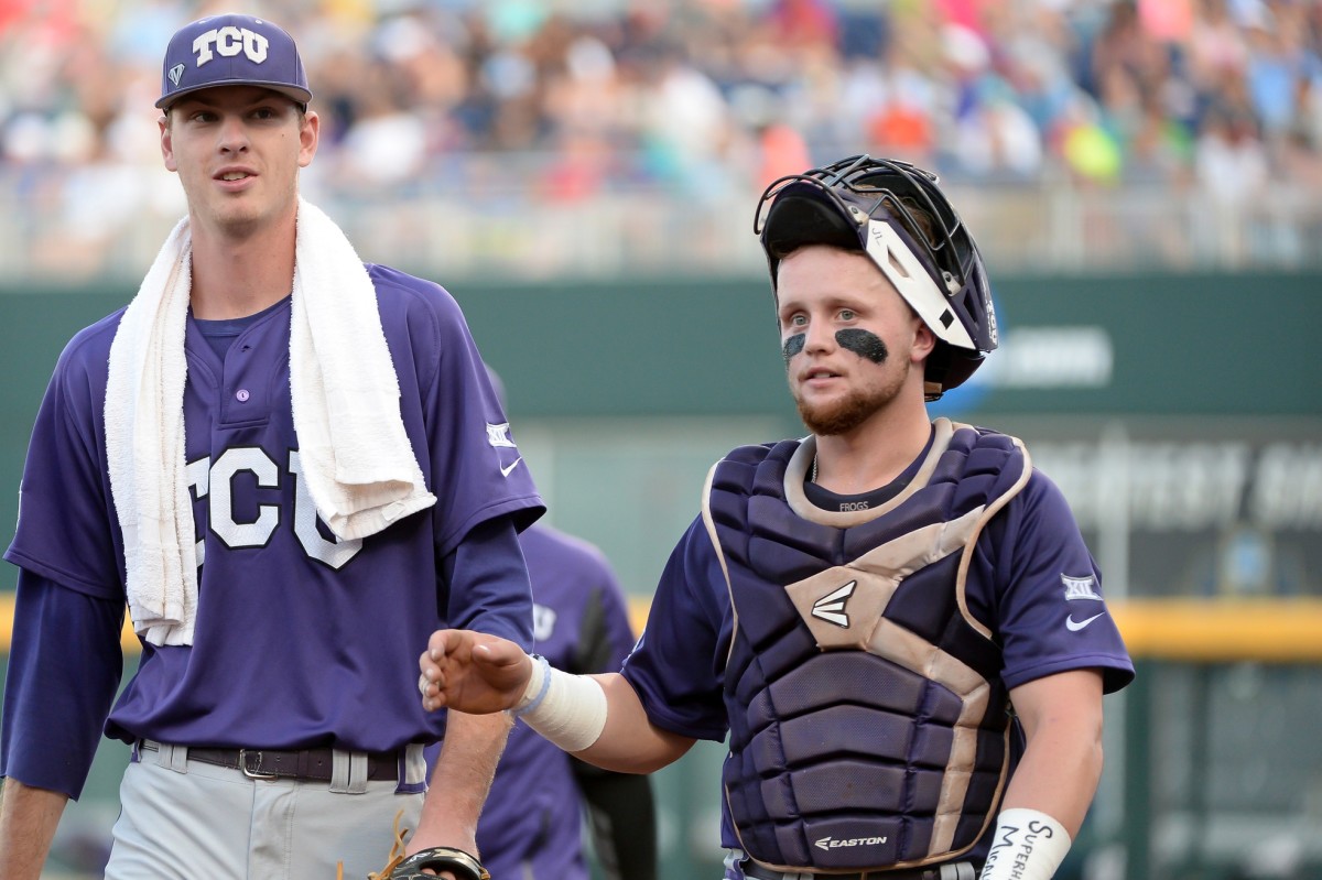 TCU Horned Frogs pitcher Brian Howard (44) and catcher Evan Skoug (9) walk to the dugout before the start of the game against the Coastal Carolina Chanticleers in the 2016 College World Series at TD Ameritrade Park.