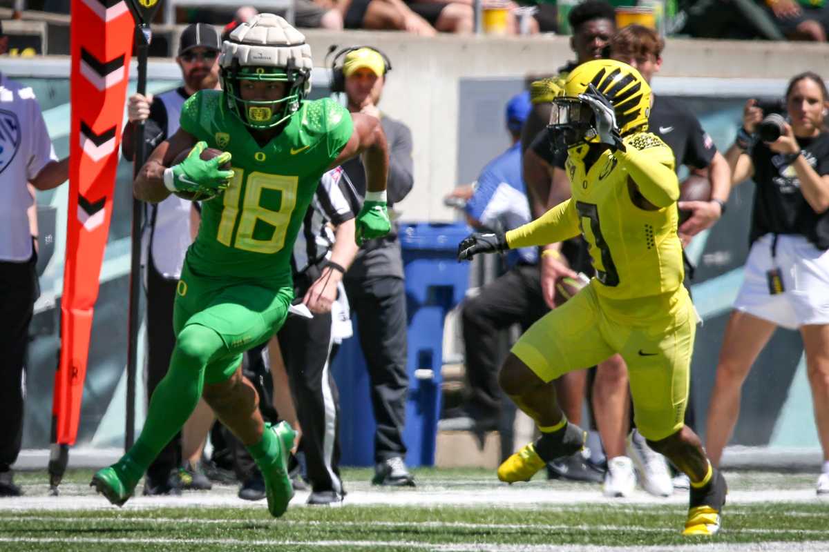 Oregon Ducks tight end Kenyon Sadiq runs after the catch in the spring game while Tysheem Johnson gives chase.