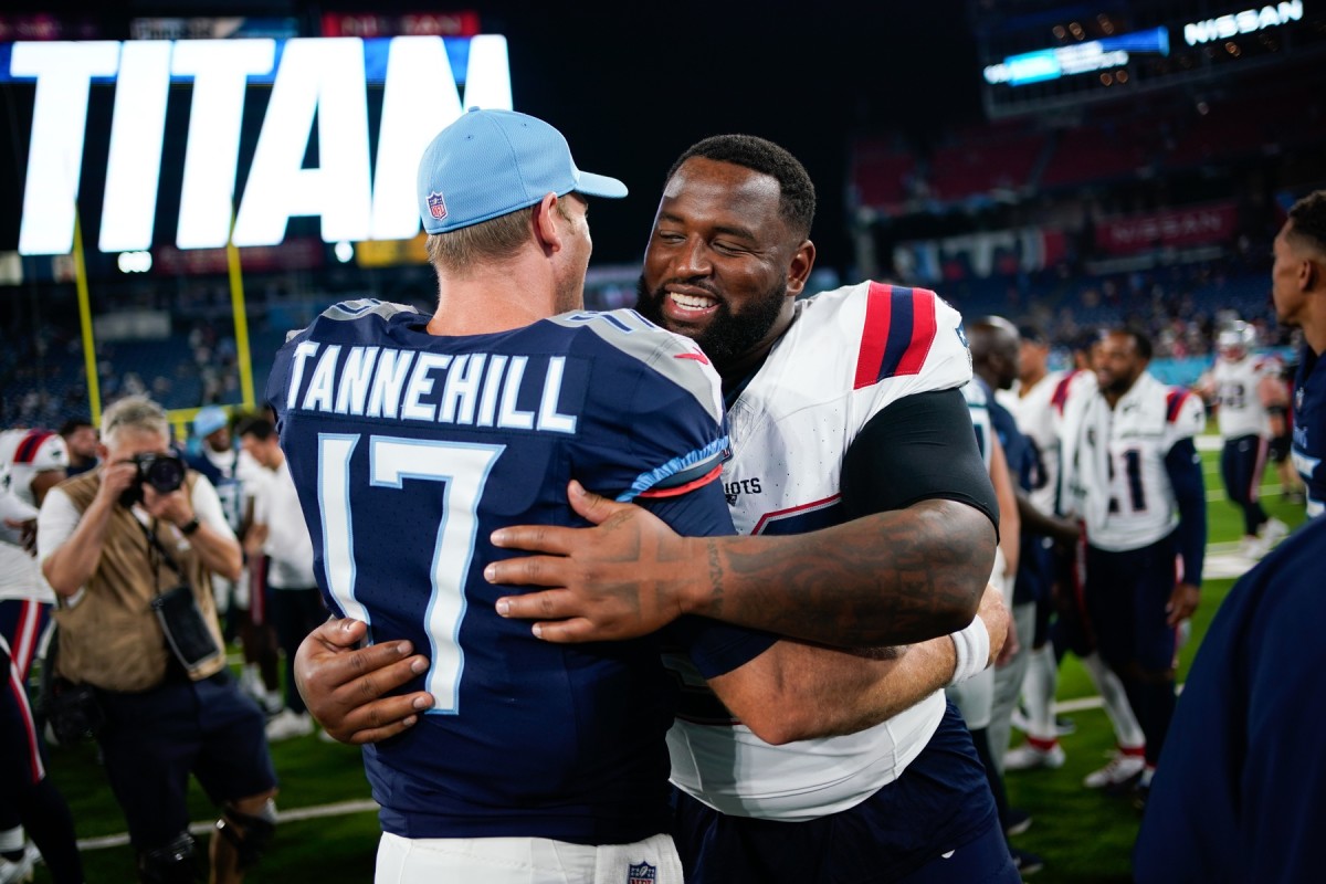 Tennessee Titans quarterback Ryan Tannehill (17) hugs New England Patriots defensive tackle Davon Godchaux (92) after the game at Nissan Stadium.