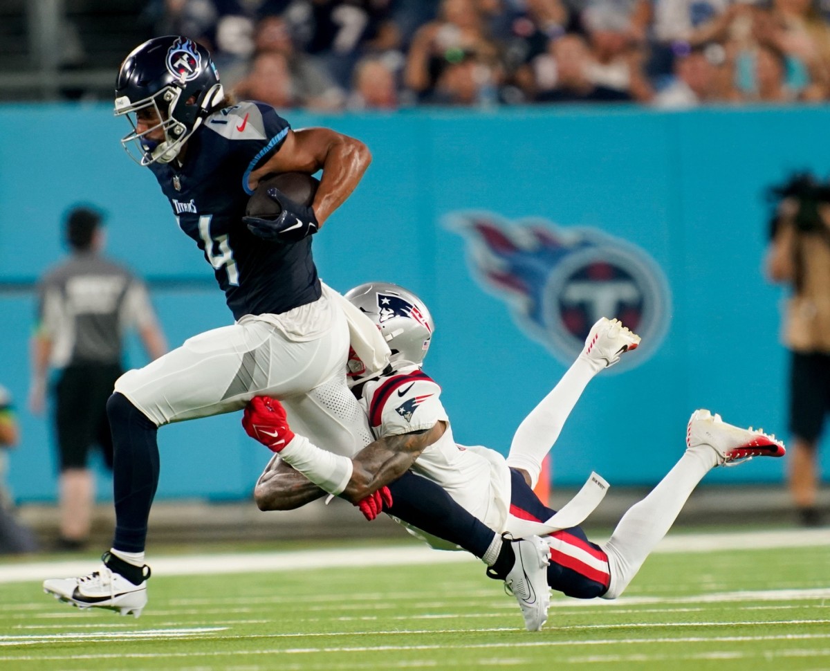 Tennessee Titans wide receiver Colton Dowell (14) picks up a first down as he is tackled during the Titans Preseason matchup with the New England Patriots at Nissan Stadium.