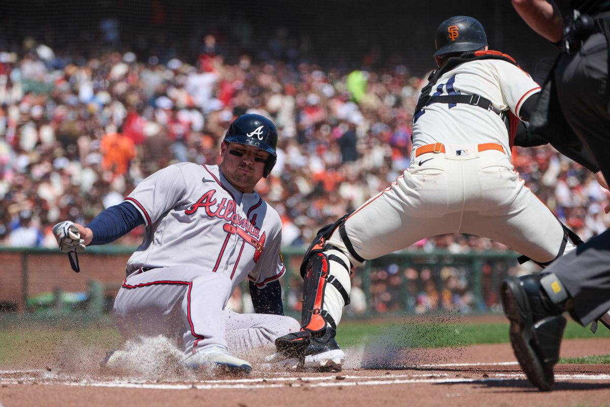 Atlanta Braves infielder Austin Riley slides safely into home against SF Giants catcher Patrick Bailey during the first inning at Oracle Park on August 26, 2023.