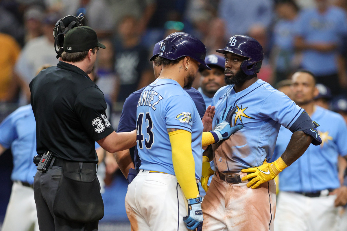 Aug 27, 2023; St. Petersburg, Florida, USA; Tampa Bay Rays designated hitter Harold Ramirez (43) holds back left fielder Randy Arozarena (56) after being hit by a pitch against the New York Yankees in the eighth inning at Tropicana Field.