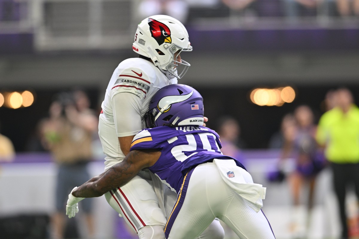 Aug 26, 2023; Minneapolis, Minnesota, USA; Minnesota Vikings safety Jay Ward (20) sacks Arizona Cardinals quarterback Clayton Tune (15) and causes a fumble that would be recovered by the Vikings during the first quarter at U.S. Bank Stadium. 