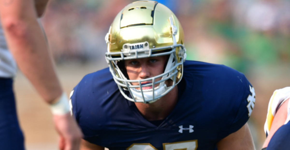 Notre Dame Fighting Irish linebacker JD Bertrand at the line of scrimmage during a college football game.