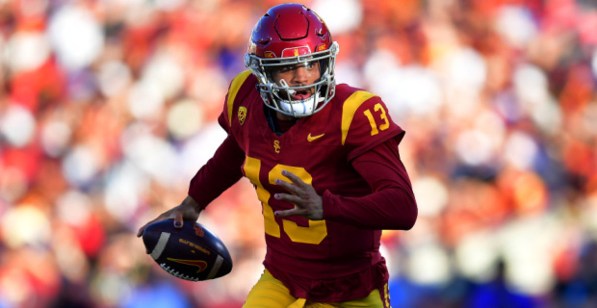 USC Trojans quarterback Caleb Williams on the run during a college football game.