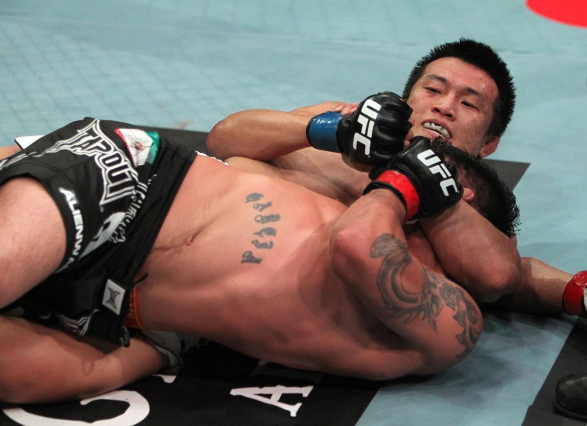 Chan Sung Jung finishes a Twister submission.