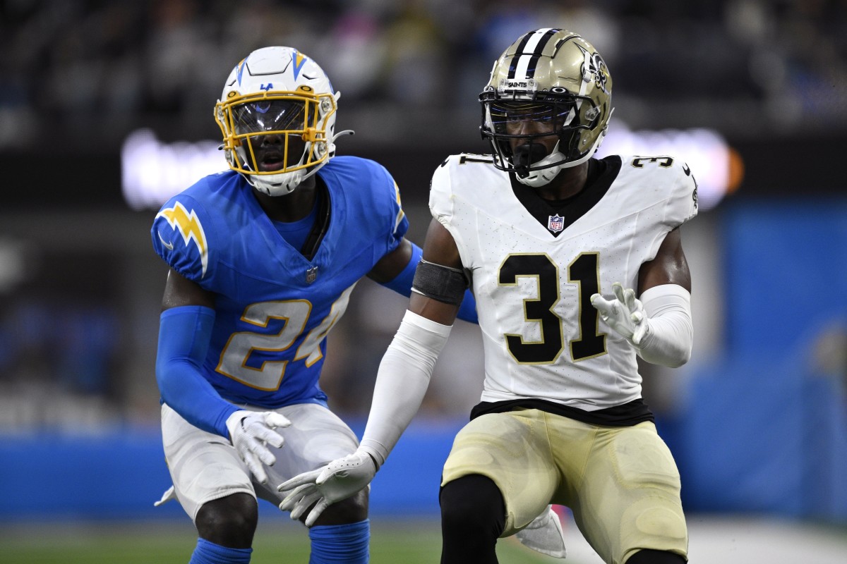 Los Angeles Chargers safety AJ Finley (24) and New Orleans Saints safety Jordan Howden (31) battle during a punt return. Mandatory Credit: Orlando Ramirez-USA TODAY Sports