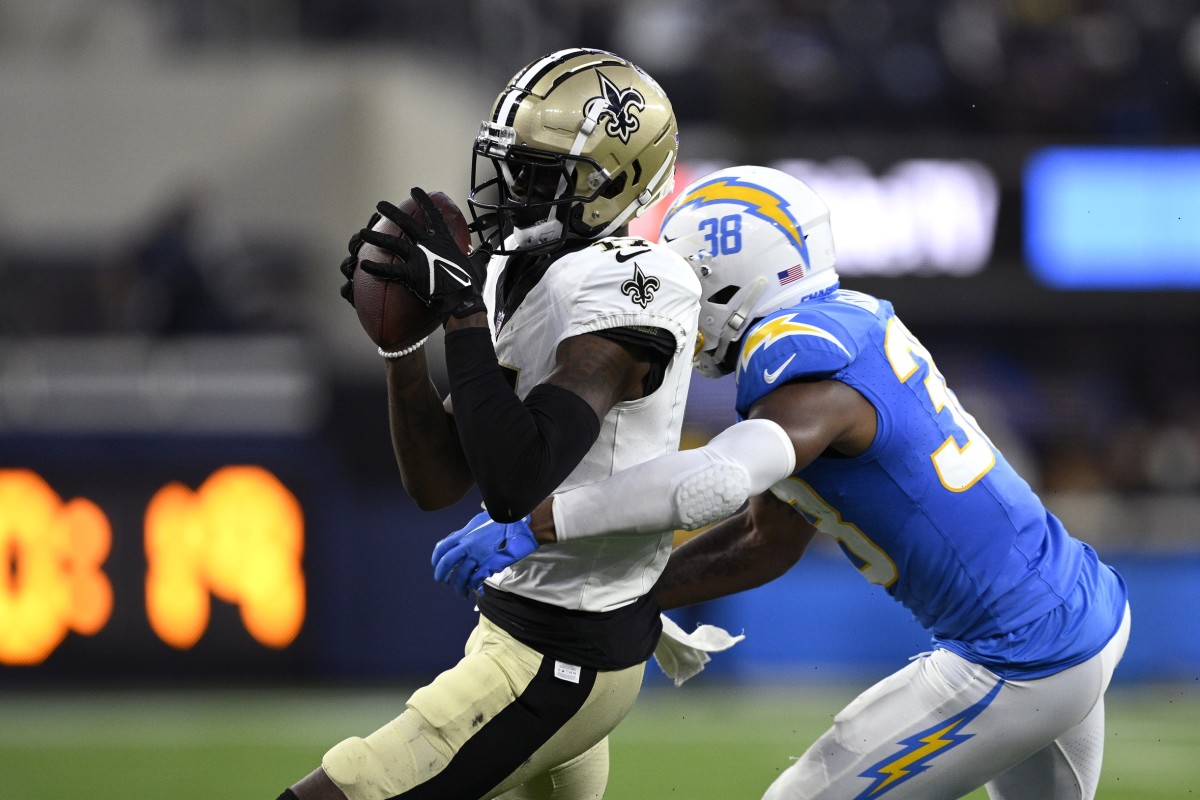 New Orleans Saints wide receiver A.T. Perry (17) catches a pass while defended by Los Angeles Chargers cornerback Cam Brown (38). Mandatory Credit: Orlando Ramirez-USA TODAY
