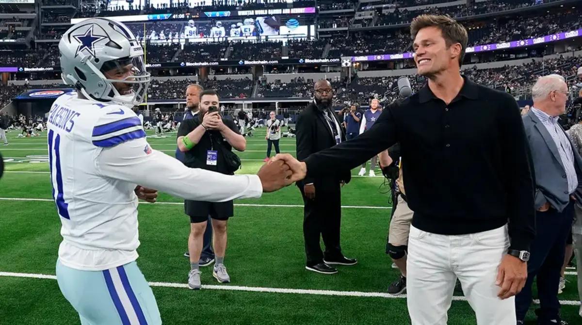 Tom Brady shakes hands with Cowboys linebacker Micah Parsons before a preseason game.