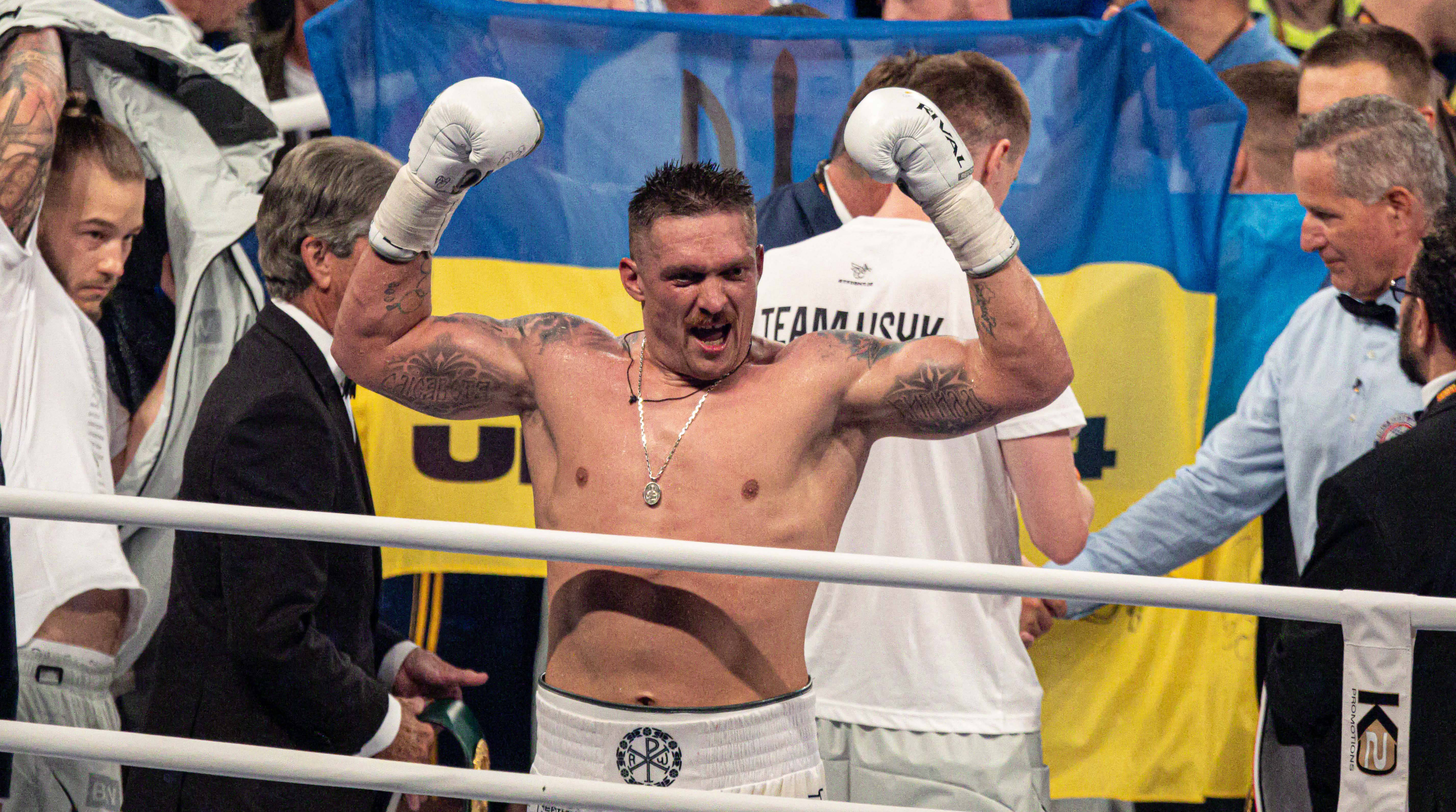 Oleksander Usyk celebrates after beating Daniel Dubois.