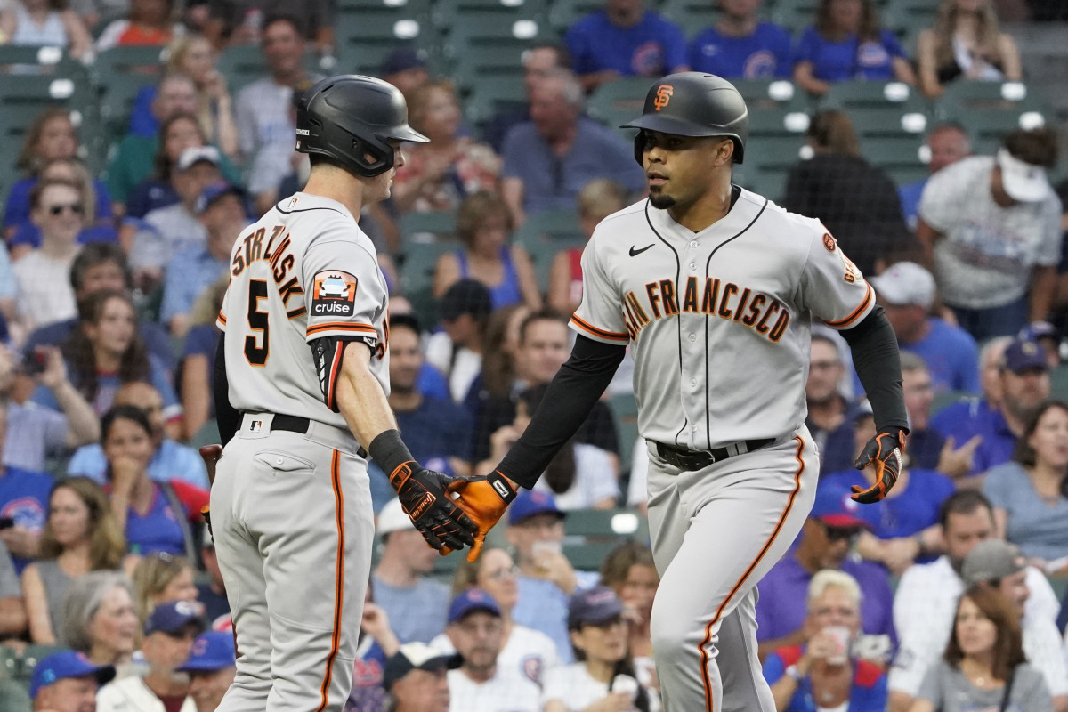 SF Giants first baseman LaMonte Wade Jr. (right) is greeted by right fielder Mike Yastrzemski after hitting a home run against the Chicago Cubs during the first inning at Wrigley Field. (2023)