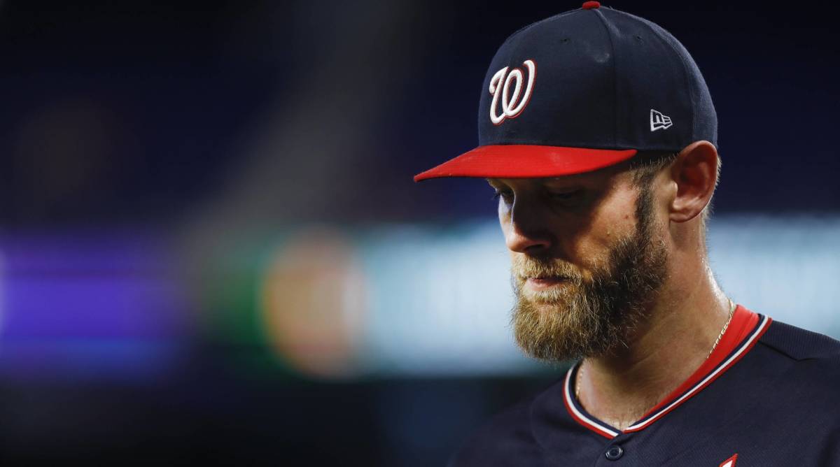 Nationals starting pitcher Stephen Strasburg looks down while walking off the mound in a game.