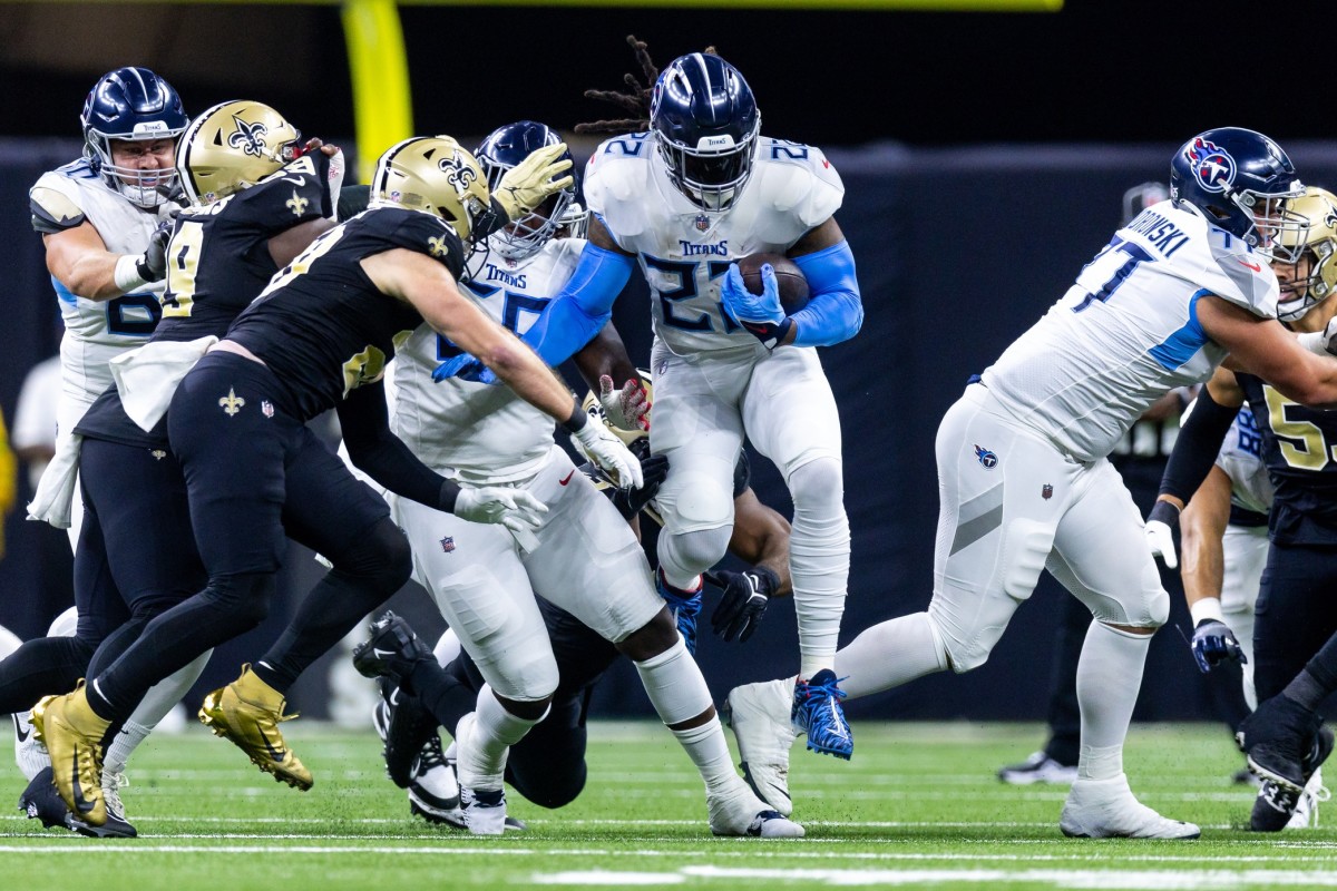 Tennessee Titans running back Derrick Henry (22) leaps over the New Orleans Saints defensive line during the first half at the Caesars Superdome. 