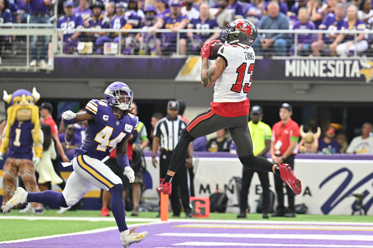 Sep 10, 2023; Minneapolis, Minnesota, USA; Tampa Bay Buccaneers wide receiver Mike Evans (13) catches a touchdown pass from quarterback Baker Mayfield (not pictured) as Minnesota Vikings safety Josh Metellus (44) defends during the second quarter at U.S. Bank Stadium. Mandatory Credit: Jeffrey Becker-USA TODAY Sports