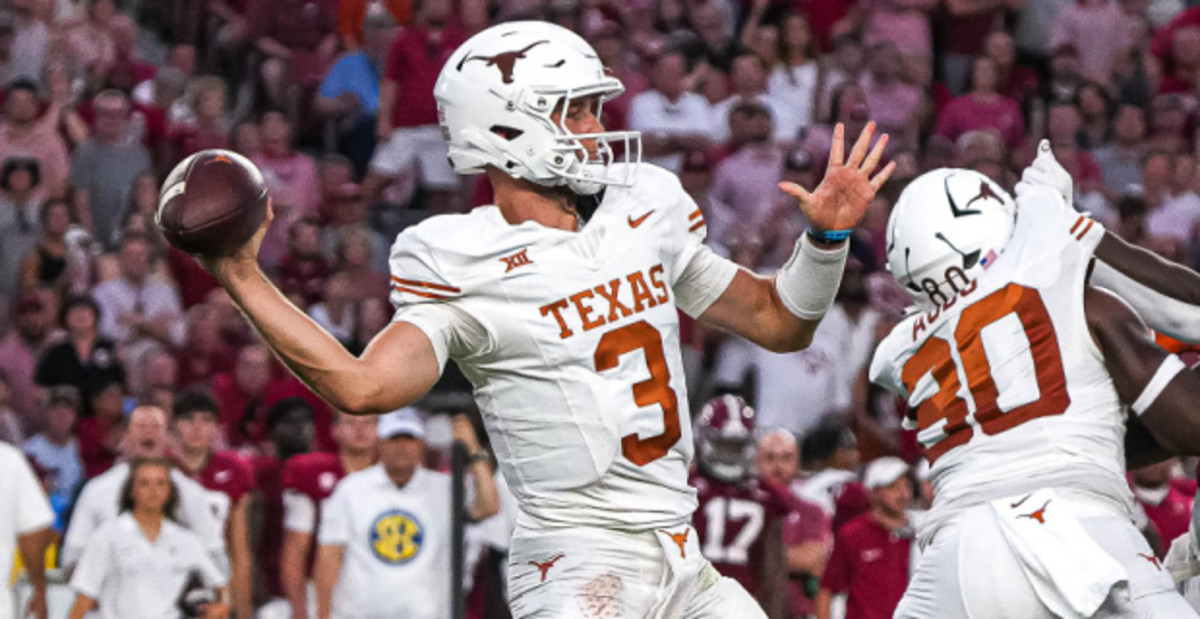 Texas Longhorns quarterback Quinn Ewers attempts a pass during a college football game.