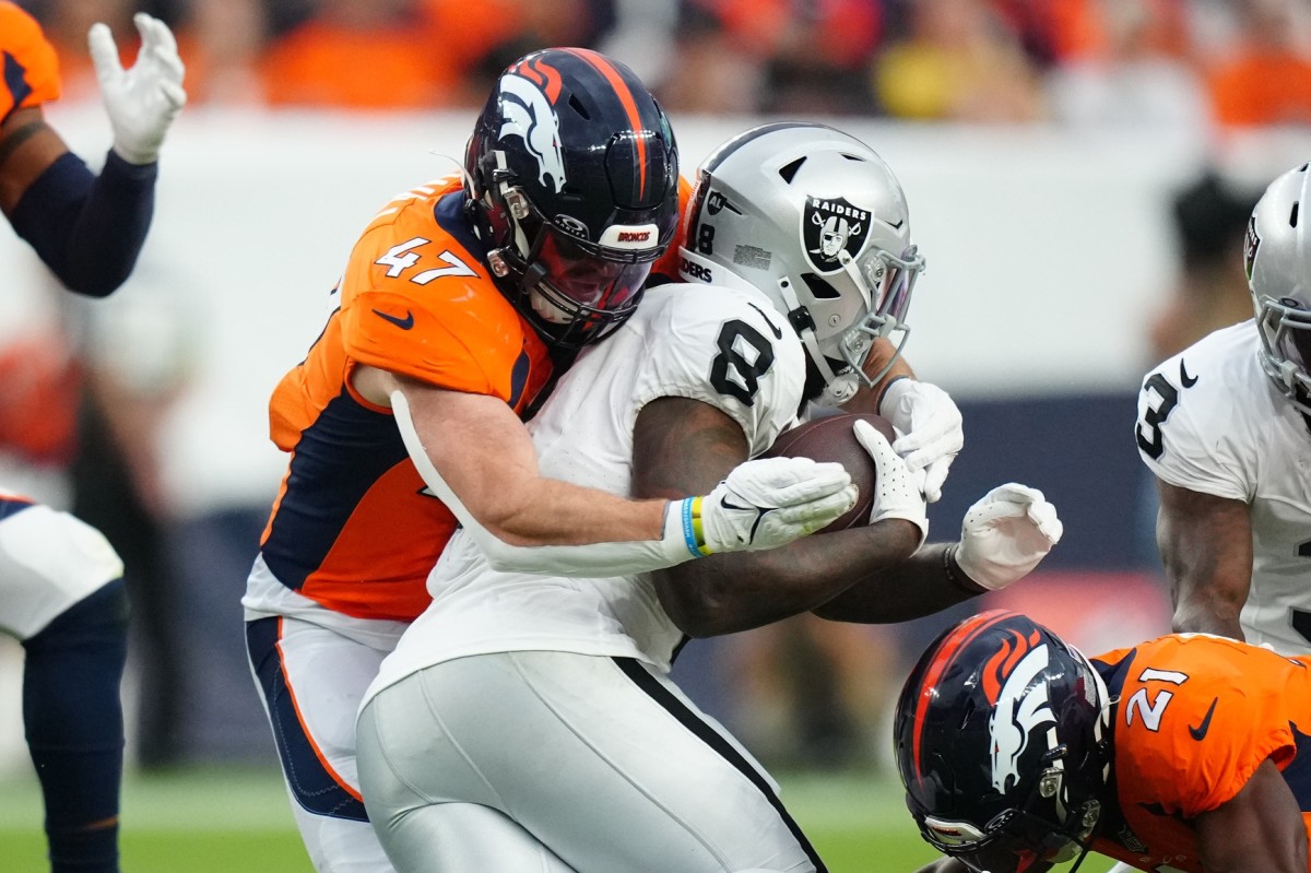 Denver Broncos linebacker Josey Jewell (47) tackles Las Vegas Raiders running back Josh Jacobs (8) in the third quarter at Empower Field at Mile High.
