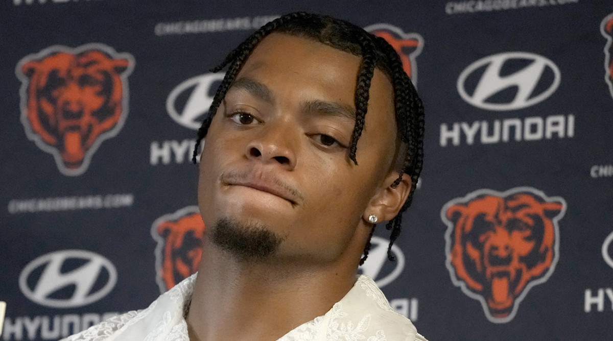 Bears quarterback Justin Fields listens to a question during a news conference after a loss to the Packers.