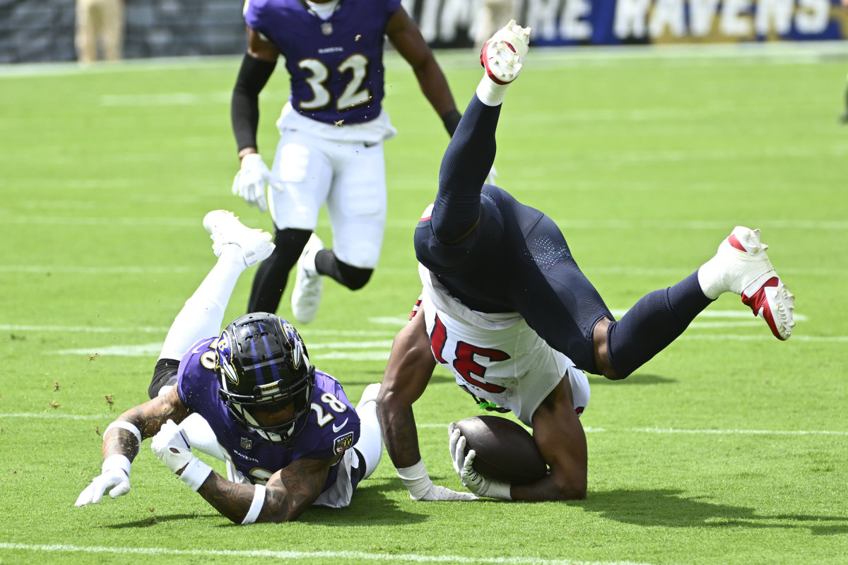 Sep 10, 2023; Baltimore, Maryland, USA; Houston Texans running back Dameon Pierce (31) is tackled by Baltimore Ravens cornerback Ronald Darby (28) during the first half at M&T Bank Stadium. Mandatory Credit: Brad Mills-USA TODAY Sports 