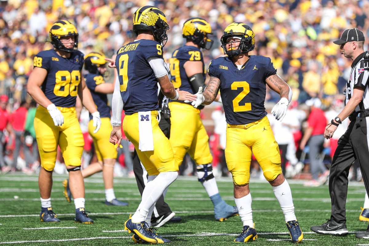 Michigan quarterback J.J. McCarthy celebrates with running back Blake Corum