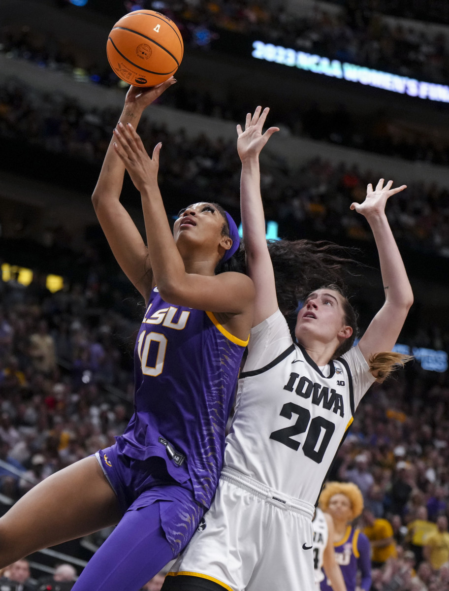 LSU forward Angel Reese drives to the basket to shoot while against Iowa guard Kate Martin during the women's NCAA championship.