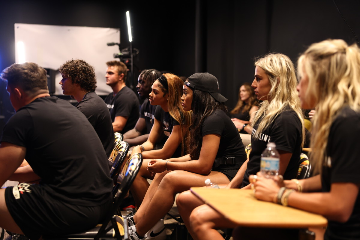 Members of WWE’s Next In Line program listen during a meeting