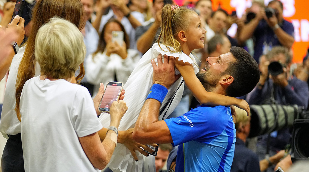 Novak Djokovic lifts his daughter to celebrate his U.S. Open title.