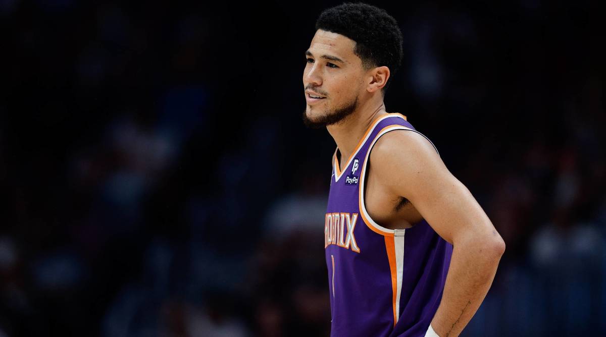 Suns guard Devin Booker looks on during a game vs. the Nuggets.