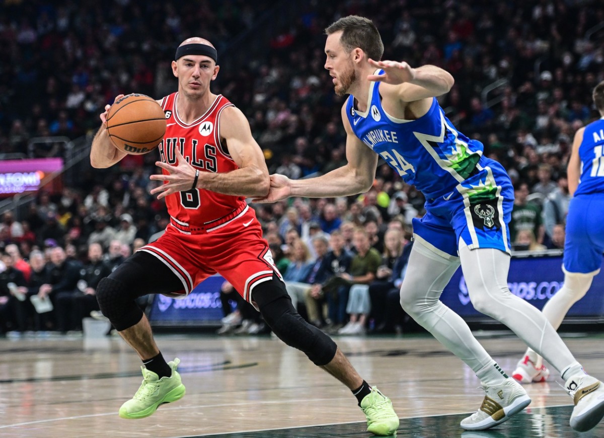 Chicago Bulls guard Alex Caruso (6) is guarded by Milwaukee Bucks guard Pat Connaughton (24) 