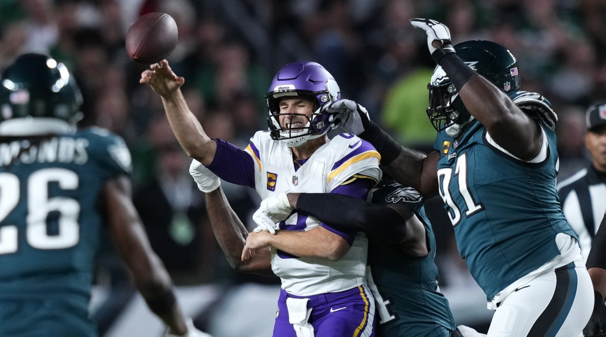 Vikings QB Kirk Cousins is hit by Eagles defensive end Josh Sweat.