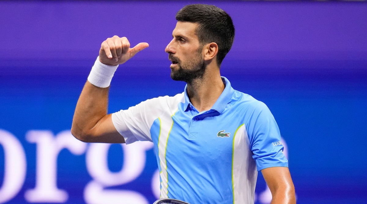 Novak Djokovic reacts by imitating the action of picking up a phone after defeating Ben Shelton at the U.S. Open.
