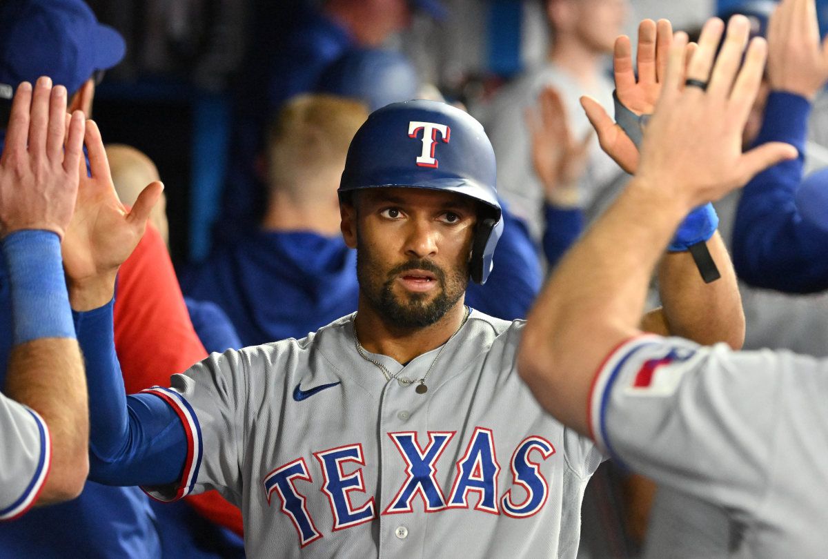 Texas Rangers second baseman Marcus Semien celebrates in the dugout with teammates after scoring against the Toronto Blue Jays in the eighth inning at Rogers Centre.