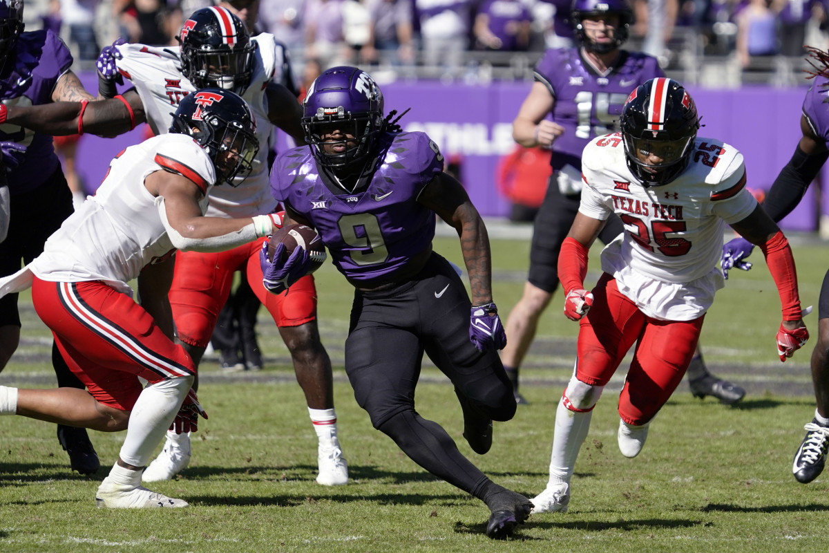 TCU Horned Frogs running back Emani Bailey (9) carries the ball against the Texas Tech Red Raiders during the second half of a game at Amon G. Carter Stadium. 
