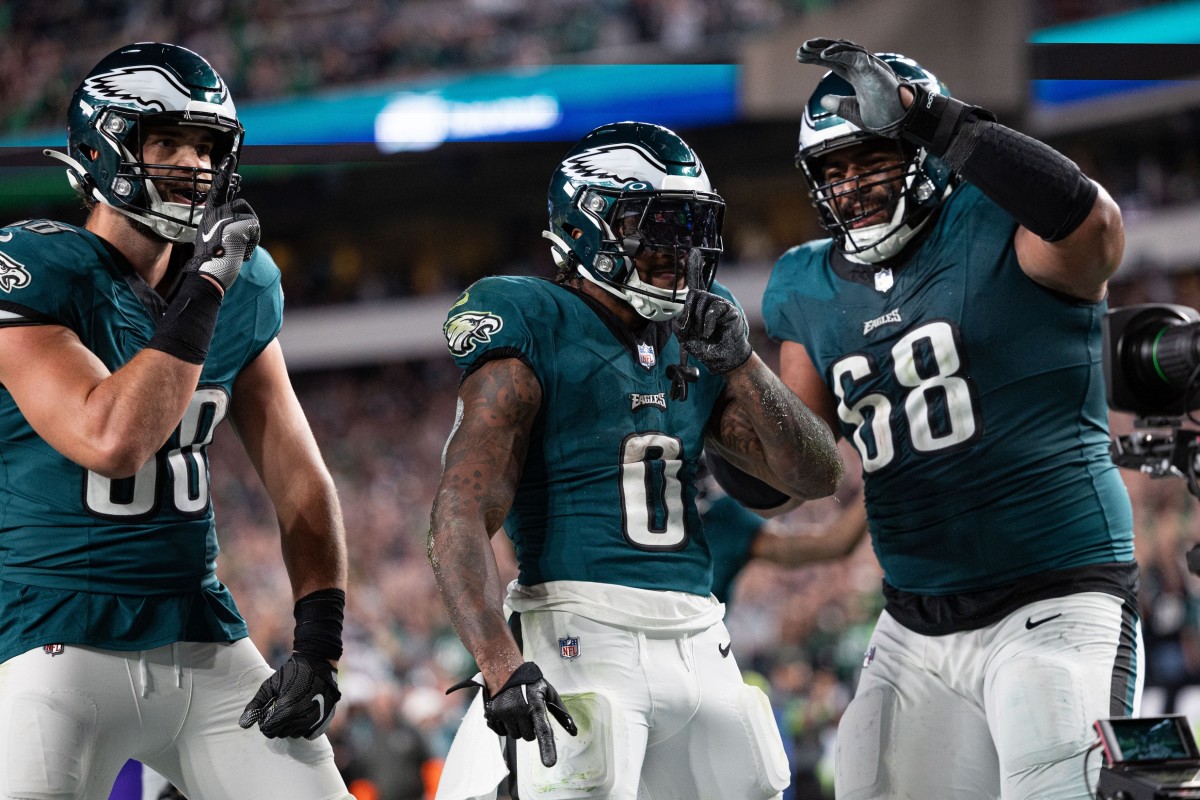 D'Andre Swift celebrates touchdown with tight end Dallas Goedert (left) and left tackle Jordan Mailata