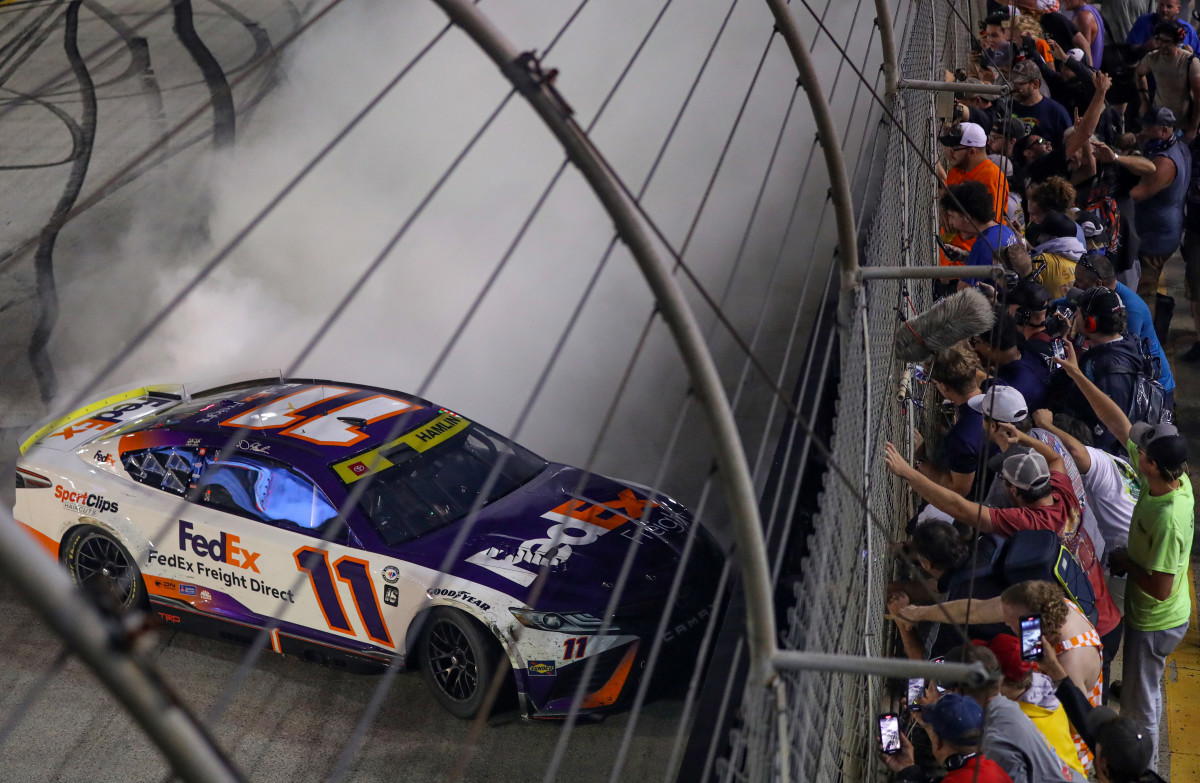 Denny Hamlin celebrates with a burnout in front of fans after winning the NASCAR Cup Series Bass Pro Shops Night Race at Bristol Motor Speedway. (Photo by Meg Oliphant/Getty Images)