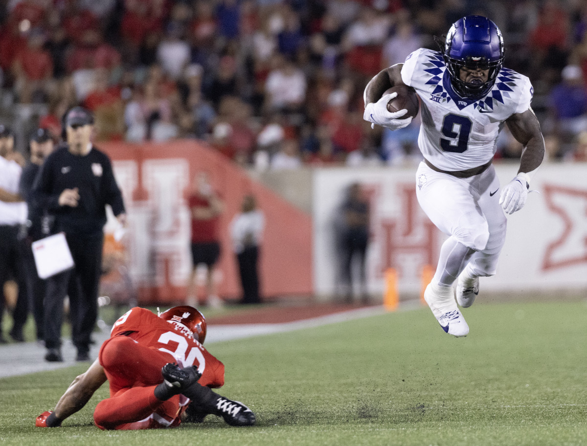 TCU Horned Frogs running back Emani Bailey (9) is tripped by Houston Cougars linebacker Treylin Payne (29) in the second half at TDECU