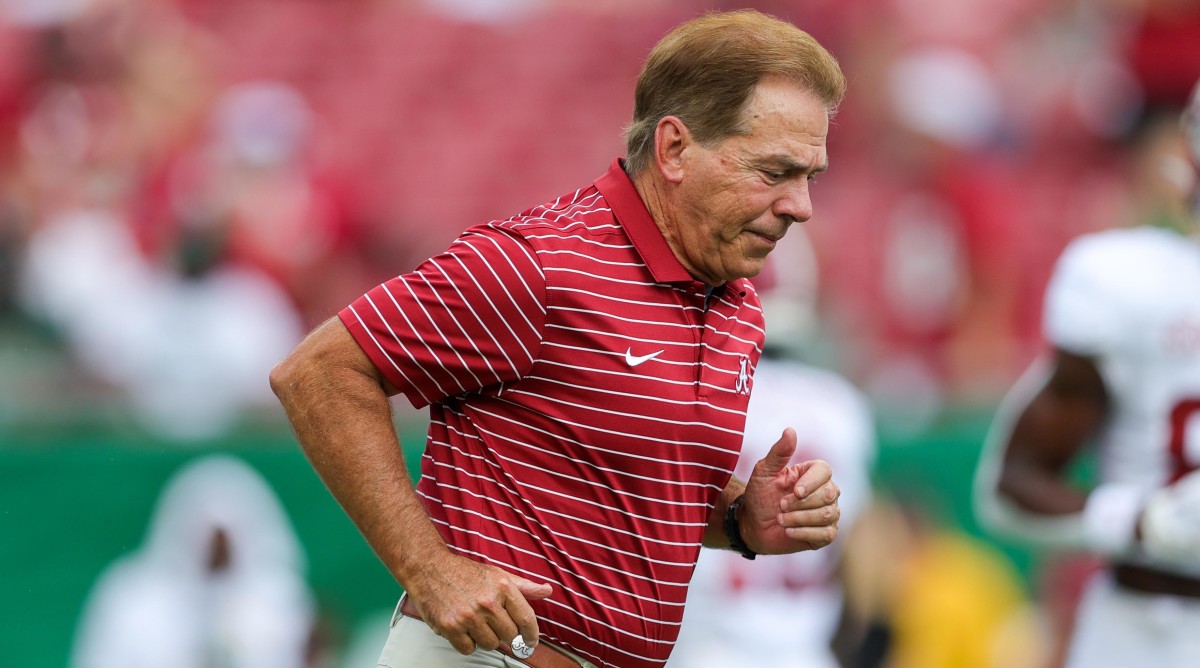 Nick Saban running out onto the field.