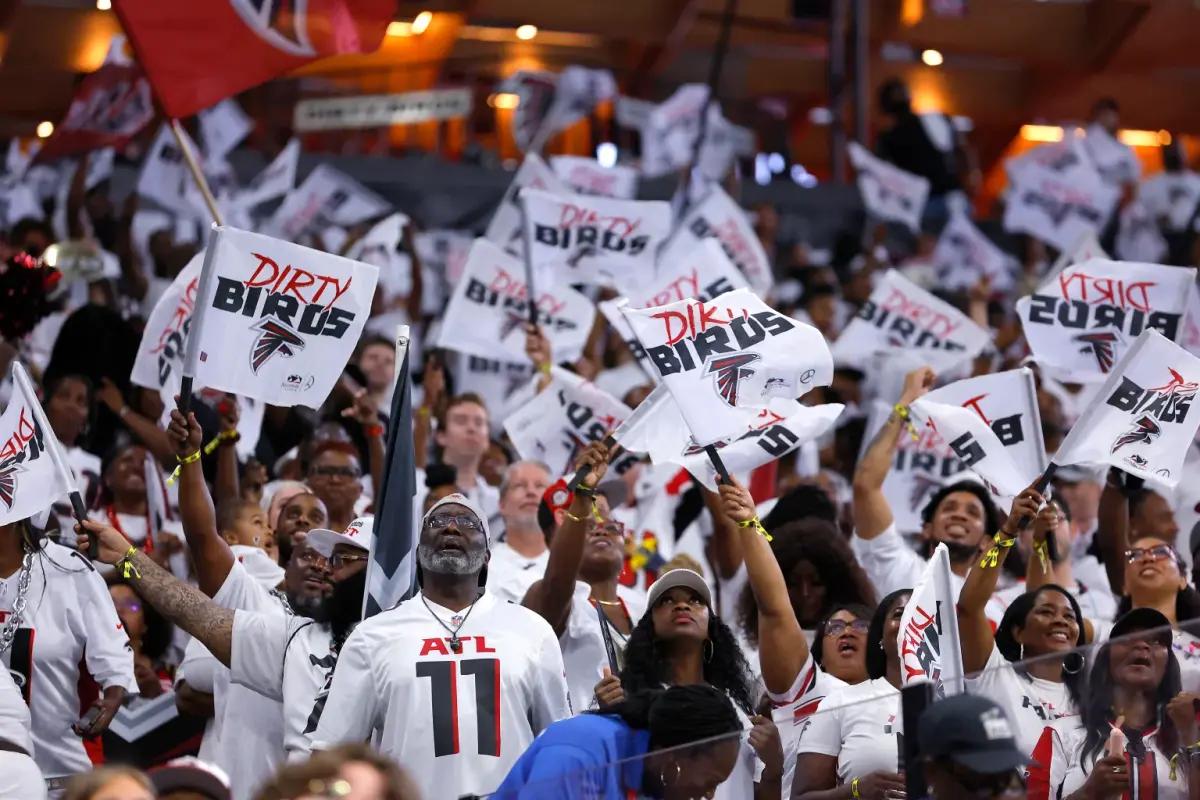 Atlanta Falcons fans cheering at Mercedes-Benz Stadium.
