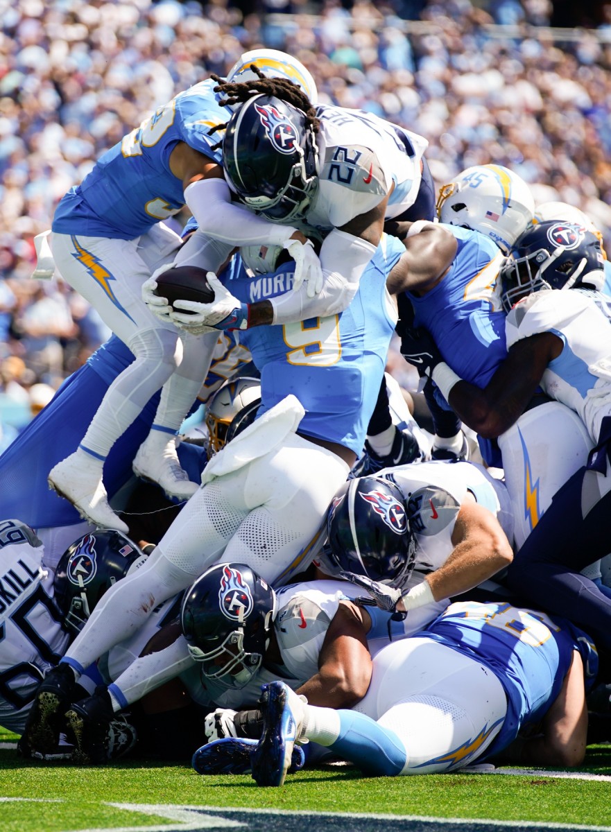Tennessee Titans running back Derrick Henry (22) jumps over the Los Angeles Chargers defense to score a touchdown.