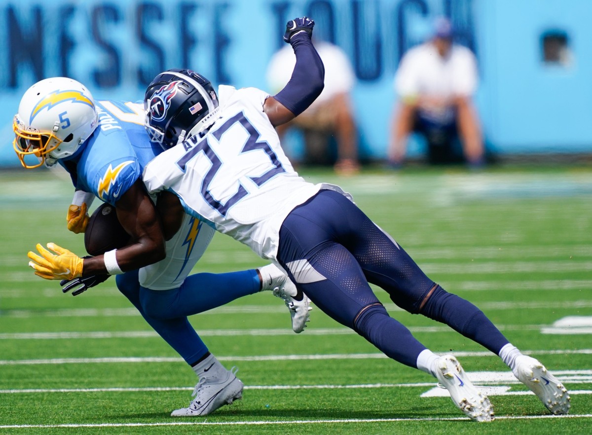 Tennessee Titans cornerback Tre Avery (23) tackles Los Angeles Chargers wide receiver Joshua Palmer (5) during the Titans and Chargers matchup at Nissan Stadium.