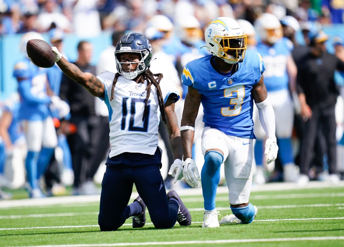 Titans wide receiver DeAndre Hopkins (10) celebrates a catch in the fourth quarter after being stopped by Los Angeles Chargers safety Derwin James Jr. (3) at Nissan Stadium.
