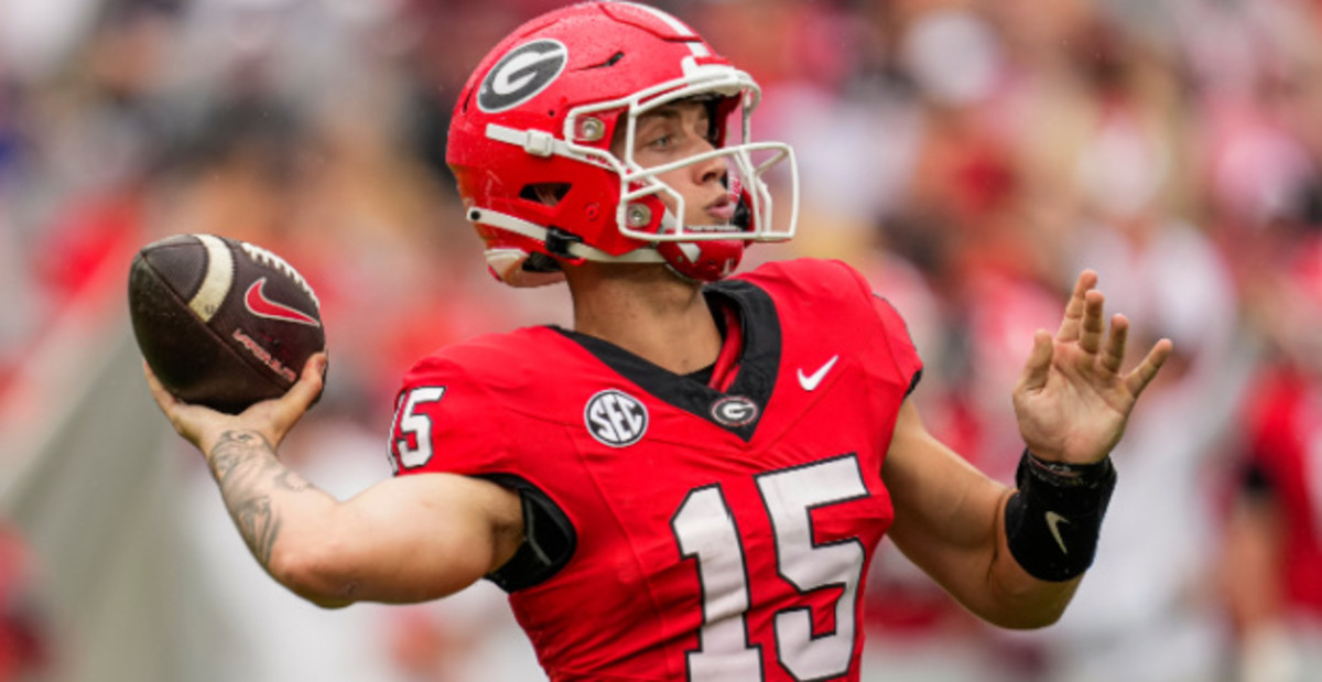 Georgia Bulldogs quarterback Carson Beck attempts a pass during a college football game in the SEC.